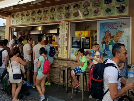 The counter at Obelix, with the photo menu board and the gyros spit