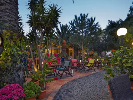 The walled garden courtyard at Pelican Kipos at dusk